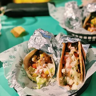 two burritos on a table