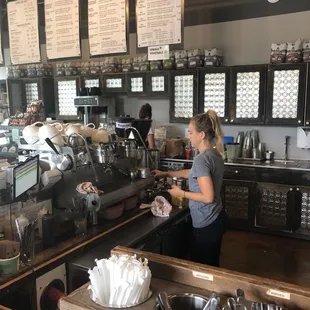 a woman preparing food in a restaurant