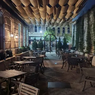 a patio with tables and chairs