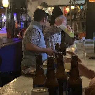 a group of people sitting at a bar