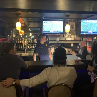 a group of people sitting at a bar