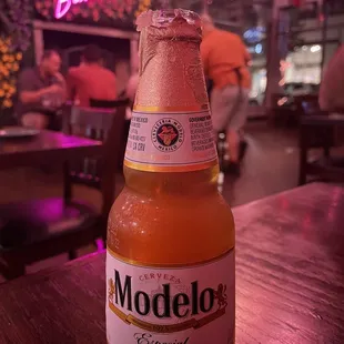 a bottle of modelo beer on a table