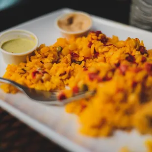 a plate of food with a spoon and sauce