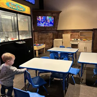 a toddler playing in a restaurant