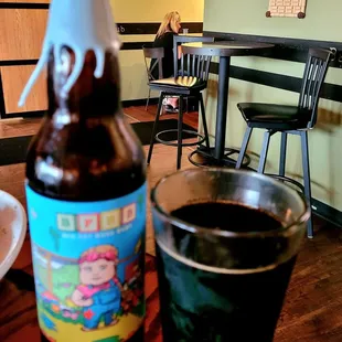 a bottle of beer and a cup of coffee