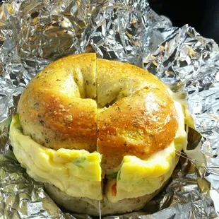 Farmers Bagel with sausage and provolone added on a Spinach and Feta bagel