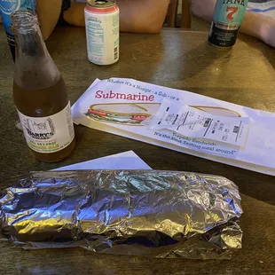 a sandwich and a bottle of soda