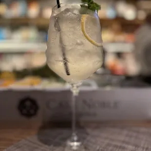a gin cocktail with a lemon slice