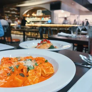 a plate of pasta and a glass of wine