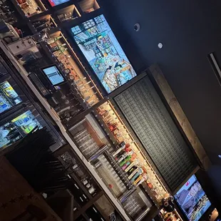 a variety of televisions in a bar