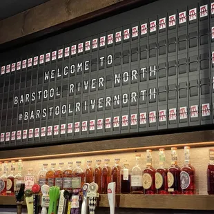 a bar with a large menu on the wall