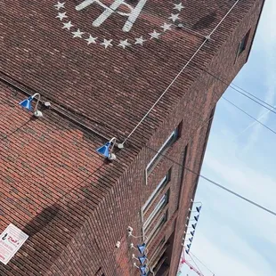  a man on a skateboard in front of a brick building