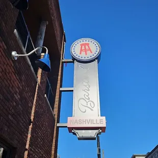  a brick building with a sign for a bar