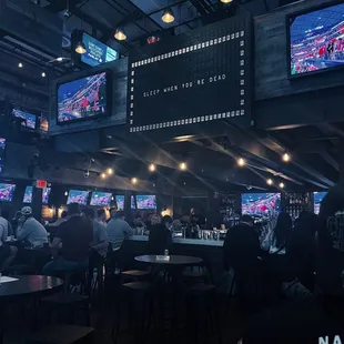 a large television screen in a sports bar