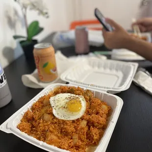 a plate of rice with an egg on top