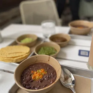 a bowl of beans and tortillas