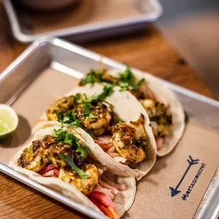 three tacos on a tray