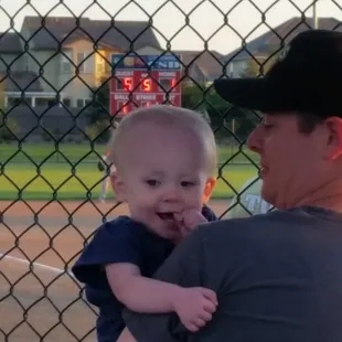 Cara telling dad (Geoff) to swing through the ball.