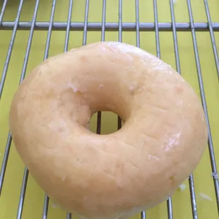 a glazed donut on a cooling rack