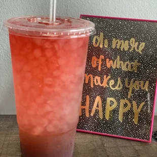 a drink in a plastic cup with a straw