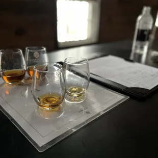 three glasses and a notepad on a table