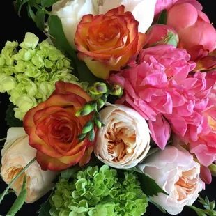 English garden roses, freesia, tea roses, peonies end green hydrangea make this arrangement special.