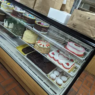 a display case full of cakes and pastries