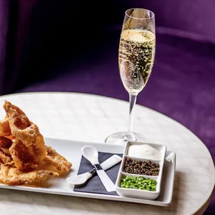 a plate of food and a glass of wine