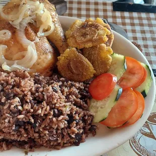 Fried chicken with cuban rice and beans, tostones, and salad