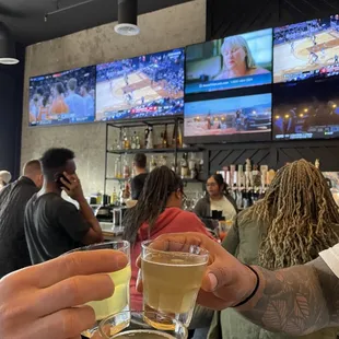 a group of people toasting at a bar