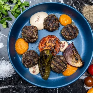 a plate of meatballs and vegetables