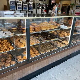 a variety of donuts in a display case
