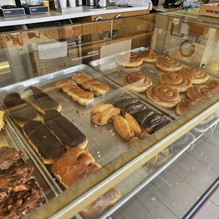 Display case of Cinnamon rolls, buttermilk bars, etc