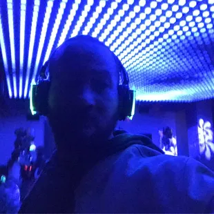 a man wearing headphones in a dark room