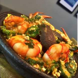 a bowl of food with shrimp and vegetables