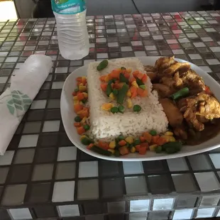 A plate of white rice and curry chicken