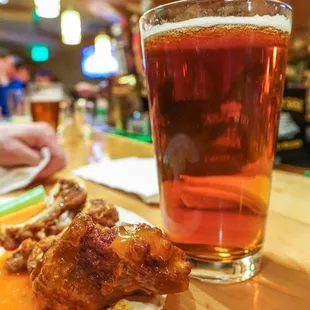 a plate of food and a glass of beer