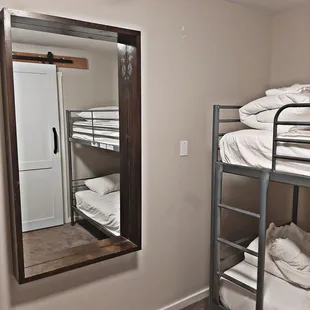 Big mirror in room with bunk beds