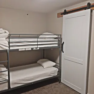 Bunk beds with sliding barn door to separate from king bed