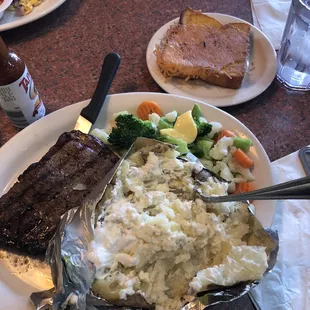 Steak, Baked Potato ,veggies and garlic bread