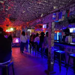 Dollar bills on the ceiling and walls. Early evening so not very crowded.