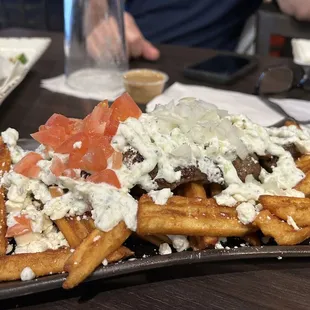 a plate of waffles topped with cheese and tomatoes