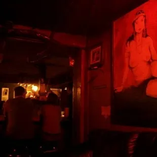 a painting of a woman sitting on a couch