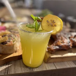 a glass of lemonade with a slice of lemon