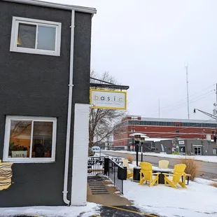 a black building with yellow chairs