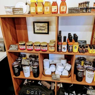 a shelf of honeys, jams, and other condiments