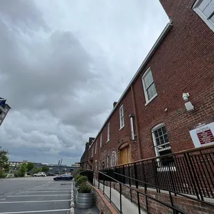a brick building with a sign on it