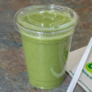 a green smoothie with a straw