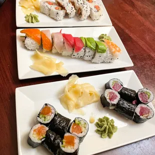 three plates of sushi on a table
