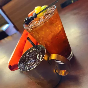 a glass of iced tea and a cup of iced tea